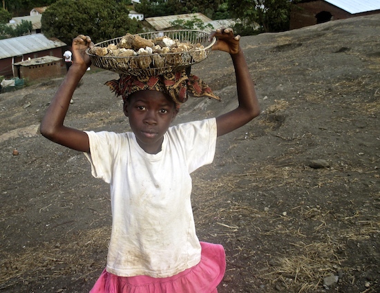 Girl carrying rocks
